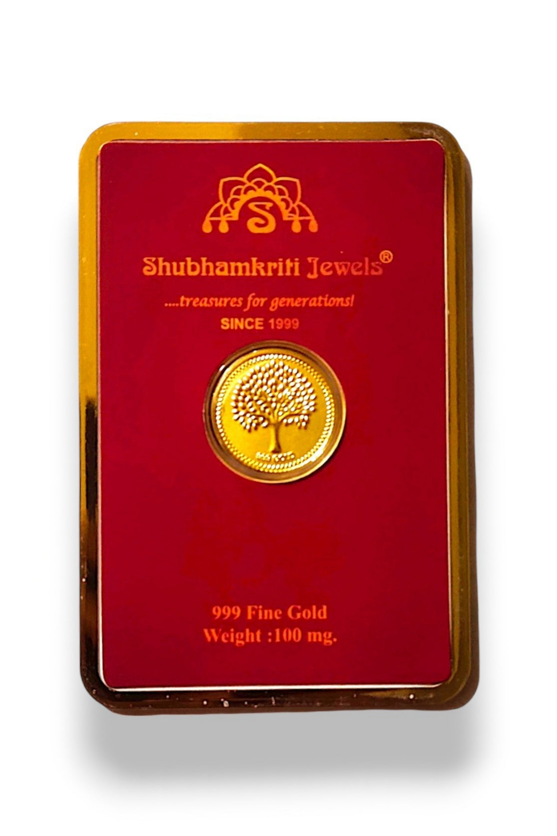 A 100 mg fine gold coin featuring a tree of life design, presented on a red backing card with gold trim. The brand 'Shubhamkriti Jewels' is clearly printed on the card.